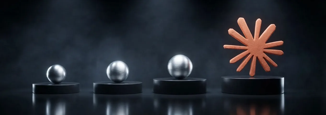 A terracotta Claude starburst on the last of four low black plinths in a row, with brushed chrome spheres of growing size on the other three, in a dark studio with white rim light.