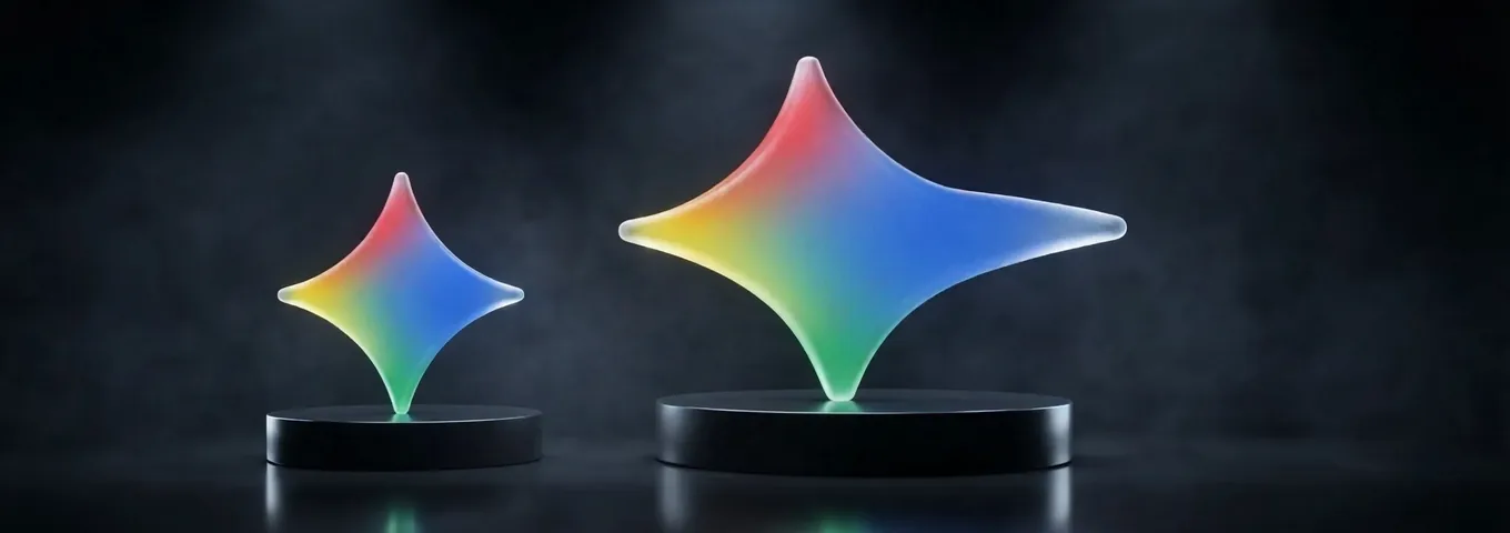 A small rainbow glass Gemini star on a short black plinth beside a larger rainbow glass Gemini star on a tall black plinth, in a charcoal studio under rim light.