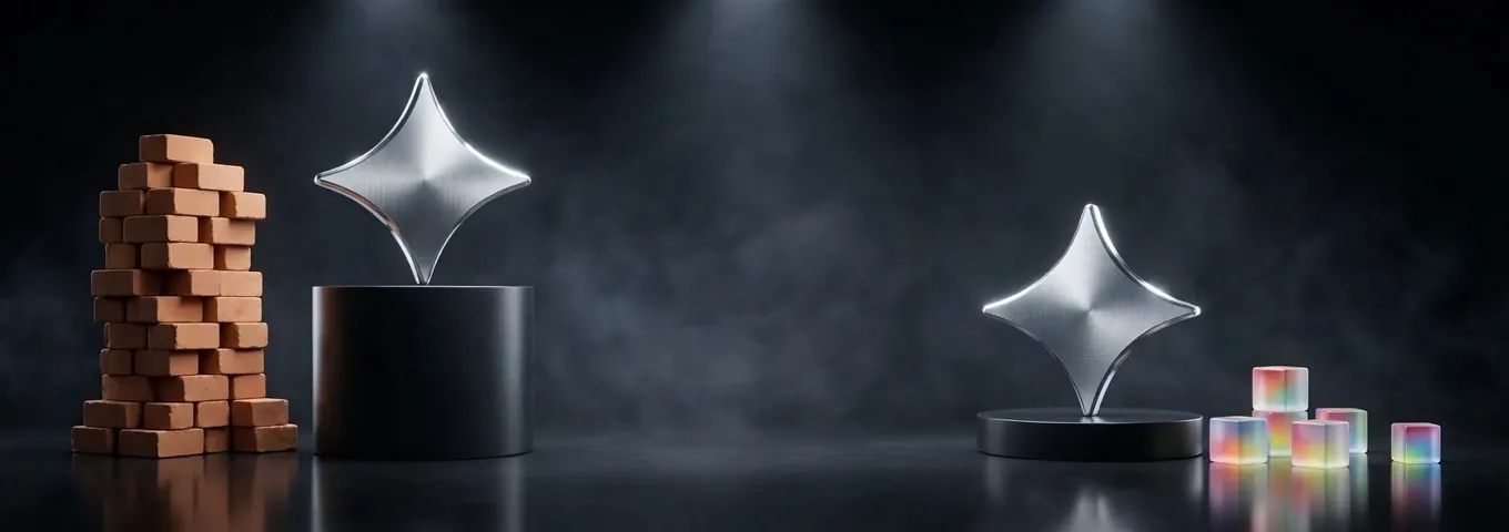Two chrome Gemini stars in a charcoal studio, one on a tall black plinth beside a tall stack of terracotta blocks and one on a low base beside a few rainbow glass cubes.